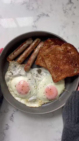 little breakfast asmr 😍🍳 fry 3-4 breakfast sausages in some butter over medium heat. flip until golden brown on both sides, then scoot them over to the side of the pan  crack 2 eggs into the pan. allow to cook for about a minute, then add a splash of water and cover. turn heat to low and cook for 2-3 minutes, until the tops of the yolks have turned white, but still have a little jiggle 🤝 toast a couple slices of your favorite bread, lather with a bit of butter. serve it up in a plate and enjoy!! #asmr #breakfast #highprotein #healthy #EasyRecipe #cookwithme 