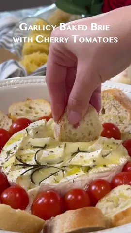 GARLICY BAKED BRIE WITH CHERRY TOMATOES Baked brie with cherry tomatoes is a truly delicious appetizer. Best parts? It’s literally takes moments to throw together! The amount of ingredients are minimal, and it’s always a show-stopper. INGREDIENTS •        2 medium cloves garlic, sliced •        1 (8 ounce) wheel brie cheese •        2 tablespoons olive oil •        Italian seasoning •        fresh rosemary •        1 small baguette INSTRUCTIONS 1.        Preheat oven to 350˚ 2.        Add brie cheese to a baking dish. Score brie cheese in a crisscross pattern by making the cuts into the brie cheese (make deep cuts, but not all the way through). Stick sliced garlic into a brie 3.        Add tomatoes & sliced baguette. Pour olive oil over the dish. Sprinkle with Italian seasoning. Add fresh rosemary. 4.        Bake for 20 min or until the tomatoes begin to burst open. #food #Recipe #brie #Foodie 