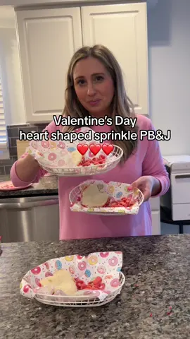 Valentine's Day heart shaped sprinkled PB&J ❤️so simple but my kids live for this 😂❤️i put some honey on and dip / shake sprinkles on the sandwich and they love it. It's so cute and festive #valentinesdaysfood #heartshape #kidfood #toddlerfood #momhacks #valentinesdayideas 