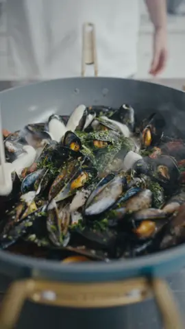 Mussels with Chorizo - Another Day In Paradise  Stanley Tucci gave me the perfect pan to make mussels - so I did! Thank you @Fortnum & Mason @GreenPan @Stanley Tucci  Ingredients  1 net mussels  100g chorizo diced 1 shallot diced 4 garlic cloves minced 4 sprigs thyme 1 cup dry white wine  1/2 cup chicken stock  2 tbsp double crème  1/2 lemon Parsley finely chopped  Toasted bread for croutons  2 tbsp olive oil  Clean and debeard the mussels - discarding any broken shells or mussels that won’t close back up when pinched shut.  Add the olive oil, chorizo, shallots, garlic, and thyme  to a pan - sauté until fragrant. Add the mussels, white wine, and stock. Cover with a lid - steam for 5-7 minutes or until the mussels open. Finish with the cream, lemon, and toasted bread. Salt if needed. 