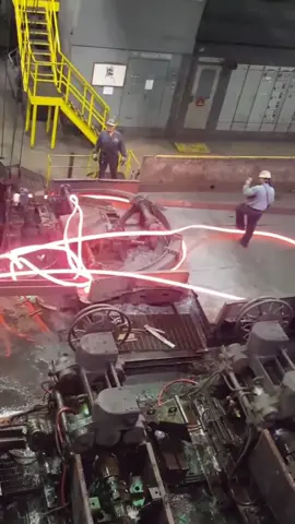 Steel Mill Cobble. A cobble happens when the rollers at a steel mill gets jammed, allowing a knot of molten steel to build up until it flings a rope of hot steel into the air. #steel #iron #molten #steelfactory #steelmill #foundry #meltingmetal #steelwork #millwright #metalwork 