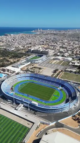 The beaming sun shining down on the Tripoli International Stadium! ☀️ | 🎥: almontaseria on Instagram | - #fyp #foryoupage #football #footy #ftbl #Soccer #futbol #futebol #footballvideo #footballtiktok #footballfans #footballpitch #footballstadium #dronefootage 