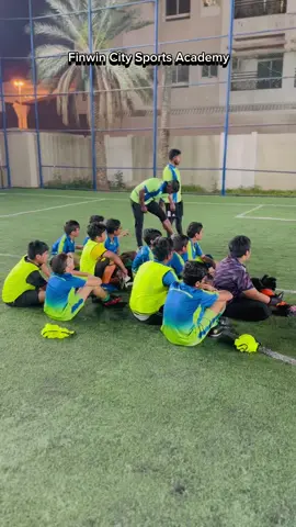 Coach Raja stood at the penalty spot, demonstrating the perfect technique to his players. 