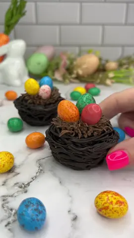 Mini chocolate nests 🍫🪺 So small they are bite-size 😋🩷🍫  Mini cupcakes hidden inside a chocolate nest, topped with chocolate buttercream and speckled eggs 🩵💗 To make these, you will need to grease the pan before adding the chocolate 🍫 I broke a few before i realised.  #cupcake #cakedecorating #easterbaking #chocolate #cakedbyrach #cutefood #minicake #caketok 