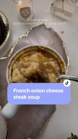 I combined two of my all-time favorite soups, French onion, and cheese steak and created this mouthwatering comforting bowl of goodness. My husband actually said this is the best soup I’ve made yet! I hope you give it a try!  ✨2 lbs of steak cubed  ✨1/4 cup flour ✨1/2 Tablespoon olive oil ✨2 Tablespoons butter ✨6 yellow sweet onions  ✨4 cloves of Garlic minced  ✨1/2 cup apple juice ✨1 teaspoon white wine vinegar  ✨1 teaspoon Worcestershire sauce  ✨1/2 teaspoon dried Thyme or 3 springs of fresh  ✨Salt & pepper to taste  ✨onion and garlic powder (optional)  ✨1/4 cup half and half  ✨4 cups of water & 2 Tablespoons of better than beef bouillon  ✨3 ounces unexpected cheddar cheese (or any aged  sharp cheddar) ✨2 ounces Gruyère cheese ✨1 ounce Parmesan cheese  ✨extra cheese for garnish  ✨ciabatta bread  1.Cube steak and pat dry; season with salt, pepper, and flour. 2.Heat olive oil in a pan over medium heat. 3.Sear steak for about 2 minutes per side(it won’t be fully cooked at this point)  and add additional seasonings like garlic powder and onion powder; remove from pan. 4.Reduce heat, add onions and butter; caramelize for 20 minutes on medium-low heat, adjusting heat if necessary. 5.Add minced garlic, apple juice, vinegar, Worcestershire sauce, and thyme; caramelize for another minute. 6.Return steak to the pan, add beef broth, bring to a boil, then lower back down to a simmer. 7.Stir in half-and-half, gradually add cheese until melted, setting some aside for topping. 8.Taste for salt, adjust if necessary. 9.Serve soup in oven safe bowls, top with toasted bread, and a handful of grated cheddar. 10.Put it in the air fryer for about 10 minutes at 450°F or until cheese is bubbly 12.Enjoy!  #cookwithme #easyrecipeideas #soup #asmrfood #inmykitchen #cookingvlog @Le Creuset #frenchonionsoup #steak #recipes 