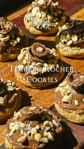Ferrero Rocher Cookies Recipe  - 10 Ferrero Rochers (Frozen)  - 115g Unsalted Butter (Cold, Cut into cubes) - 190g Brown sugar - 1 Tsp Vanilla Extract - 1 Egg (Cold) - 245g Plain Flour - 1 Tbsp Cornflour  - 1/2 Tsp Baking Soda - 1/4 Tsp Salt  - 200g Milk Chocolate Chips  - 50g Toasted Hazelnuts (Roughly Chopped)  Cookie Toppings: - Nutella To Garnish - Toasted Hazelnuts To Garnish (Finely Chopped)  - Ferrero Rochers To Garnish (Chopped In Half)  - Unwrap the Ferrero Rochers and place them in a small bowl. Freeze for about an hour.  - In a large mixing bowl, beat together the cold butter and sugar until combined. - Add the vanilla and egg then beat again until just combined.  - Fold in the flour, cornflour, baking soda and salt until just combined (Don’t Overmix). - Fold in the chocolate chips and chopped hazelnuts until evenly combined.  - Cover the cookie dough with plastic wrap and refrigerate for about 45 minutes.  - Preheat the oven to 160 degrees Celsius (Fan) and line two baking trays with parchment paper.  - Spoon a medium sized ball of cookie dough into your hand and flatten slightly. Place the frozen Ferrero Rocher in the centre of the cookie and mold the cookie dough around it, sealing it in.  - Place the cookie balls on the prepared baking trays, evenly spaced in case of spreading.  - Bake for 15 minutes or until golden.  - Allow to cool slightly. Spoon small amounts of Nutella on each cookie, then spread it to evenly coat the tops with a teaspoon.  - Sprinkle the finely chopped hazelnuts on top. Place your chopped in half Ferrero Rochers on top of each cookie (You may need to put a little bit of Nutella under the Ferrero Rocher to help them stick better on top of your cookies).  - Enjoy!  #ferrerorocher #cookies #EasyRecipe #Love #bake 