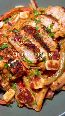 My motivation recently to cook has been next to 0 but I feel like it is coming back gradually so with some of that motivation yesterday I whipped up this amazing cheesy chicken fajita pasta…look at that cheese pull 😍 To make 2 portions of this you will need: 2 chicken breasts 150g pasta 2tsp smoked paprika 1tsp cumin 1tsp chilli powder 1tsp oregano 1tsp corriander 1tsp onion powder 1tsp garlic powder Pinch salt & pepper 3 garlic cloves minced 1 chicken stock pot 2tbsp @philadelphia_uki  2tbsp tomato puree 1/2 red onion diced 1/2 red pepper sliced 1/2 green pepper sliced 50g grated cheese 50g halloumi (optional but highly recommended) Flatten the chicken breasts until they are around 1cm thick. Mix all of the herbs & spices together then coat the chicken with half of it. Fry off the chicken on a high heat for a few mins either side to get it chargrilled then cook for another 5 mins on a medium heat until cooked through. You can also cook this in the airfryer for 15 mins at 190 Place the pasta on to boil as per the packet instructions. Remove the chicken from the pan then to the same one add in the onion & peppers with a drizzle of oil and fry off for 5 mins. Add in the garlic, stock pot and around 100ml of the pasta water then leave to simmer for a few mins. Add the rest of the herbs & spices, tomato puree and cream cheese mix until fully combined & bring to a simmer until the sauce starts to thicken up. If you are having halloumi with it fry this off at this point in small chunks. Add in the cooked pasta and the grated cheese, stir through until fully coated then top with the chicken and leave on the heat for another 5 mins to warm through.  Top with some fresh coriander & chilli flakes (optional) as well as the halloumi if you are using it and then enjoy….😋