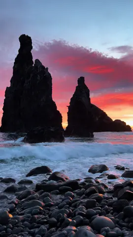 📍Ribeira da Janela, Madeira, Portugal 🇵🇹  This location on the north of Madeira has 3 islets: 🪨 Ilheu Zinho, the smallest, 🪨 Ilhéu da Rama, the middle sized one, 🪨 Ilhéu Alto (or Ilhéu Comprido) the largest one. The islests lie about 200m off the shore of Madeira (650ft), near the mouth of River Ribeira da Janela. They are composed of volcanic rocks. Praia Ilheus da Ribeira da Janela beach - sea stacks The largest one is the most famous. It is 40m high (131ft), the equivalent of a 13 storey-building. At the top of this large one, there is a small hole, called Window. This is what gave the name to the village, river and valley.  It is actually difficult to see the hole from the beach, but you can visit this place in your trip on Madeira and find it from the left side hill of the coast 😉 Ribeira da Janela means “creek or river of the window” 💁 . . . . . . #VisitMadeira #Ribeiradajanela #MadeiraLovers #travelPortugal #travelMadeira #travelblogger #rockstone #earth_deluxe #Oceanshore #PlacesToVisit #shotoniphone13pro #NorthCoast #Goldenlight #GoldenHourLight #stayadventurous #earthoutdoors #SunriseLover #SunriseView #BeautifulDestinations  #madeira #madeiraisland #welovemadeira #sunrise_lovers #portugal #portugallovers #portugaltravel #portugal_lovers 