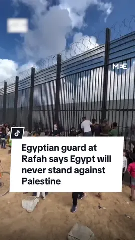 An Egyptian guard at the Rafah border with Gaza assures Palestinians on the other side that 