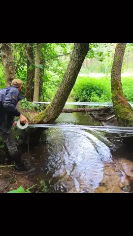 Build a great shelter over the water using plastic wrap. #camping #bushcraft #camp #survival #howtobuild #treehouse #viral 