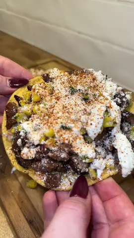 carne asada tostadas with corn salsa 🤌🏻 This makes about 4 tostadas so double the recipe if needed, or cut in half.  ingredients: 1.5 lb skirt or flank steak (i’m using tenderized inner skirt steak, but outer skirt steak is more tender & flank steak works too!) 1 tablespoons honey ¼ cup soy sauce Juice of 2 limes  ½ cup olive oil 1 goya packet ½ tsp cumin ½ tsp oregano ½ tsp ancho chili powder ½ tsp smoked paprika corn salsa: 10 oz bag of frozen corn, thawed and cooked according to directions on back  ¼ red onion finely diced ¼ cup cilantro finely chopped 1-2 jalapenos, finely diced Salt Juice of ½ lemon serving: Cotija cheese Chili lime seasoning Greek yogurt or sour cream Lime juice Guacamole Tostadas Whisk ingredients for marinade in a small bowl and transfer to a large resealable bag with the skirt steak or steak of choice.  Marinade steak 3-4 hours. Prepare corn salsa by mixing corn, onion, cilantro, jalapenos, salt and lemon juice. Grill steak & cut in thin strips against the grain and then dice in opposite directions. Layer tostada with a thin layer of guacamole, chopped up skirt steak, corn salsa, greek yogurt, cotija cheese & chili lime seasoning.  Serve! #summervibes #elote #carneasada #EasyRecipe #LearnOnTikTok #highprotein 