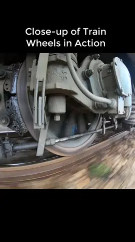 Close-up of train wheels operating on flooded tracks