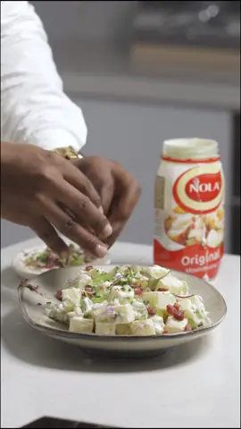 BEST POTATO SALAD If you’re looking for a no-fuss potato salad to enjoy with your favourite braai meats, your search stops here. This potato salad checks off all the boxes. Learn how to make a potato salad with this easy recipe! The perfect BBQ side dish, it’s creamy, flavourful and delicious. Made with onions, celery, bacon and @nolamayonnaise original mayonnaise.  Ingredients :  1 cup Original Nola Mayonnaise, more if needed  1 kg Potatoes, cut in cubes and boiled  250 g Diced bacon, cooked till crispy  3/4 cup Cucumber, seeded and finely diced  3/4 cup Celery, thinly sliced  1/4 cup Red onion, finely diced  1/2 tsp Kosher salt, seasoning  1/4 tsp Black pepper Instructions :  1. For your potatoes, dice your potatoes, place your potatoes, 2 teaspoons of salt in a large pot of cold water and bring to a boil. Once the water is simmering, cook for 5 -8  minutes or until the potatoes are just cooked (still bit firm in the middle). They will continue cooking with residual heat. Drain immediately. Cool slightly before mixing your salad.  2. In a mixing bowl or plate, add your potatoes, most of the celery, cucumber, onion, bacon, seasoning and your Original Nola Mayonnaise, toss gently to combine.  3. Carefully transfer potato salad onto a serving platter plate, top with celery, more cucumber, bacon and edible greens for garnish.  4. Serve with your favourite roast and enjoy.  #nolamayonnaise #creamyanddelicious  #createastire #potatosalad #foodphotography #Foodie #tiktok #trending #sama28 #Foodie #dishesbychefalbert #chefalbert #quickandeasy #bbqsidedish 