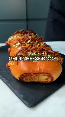 Chili Cheese Dogs 🌭 Recipe in caption below👇🏼  I had some leftover hotdogs from my Korean corn dog video  so HAD to make a chili and some fresh hotdog buns to build the ultimate chili dog. Topped with cheese, jalapenos, sour cream and crispy onions 🔥 This chili is  PERFECT one for hotdogs, but can also be used really well as a main, served with rice. See notes below for bulking it out with kidney beans for a more substantial meal. Serves 4-6 as a main, but many more as a hotdog topping - Olive oil - 1 green bell pepper - 2 vine tomatoes - 1 jalapeno - 500g beef mince - 1 onion, finely diced - 2 tbsp ground cumin - 1.5 tbsp ground coriander - 1.5 tbsp smoked paprika - 1 tbsp chilli powder (adjust depending on how spicy you want it - this recipe is spicy) - 0.5 tbsp chilli flakes - 0.5 tbsp garlic powder - 0.5 tbsp onion powder - 3 large cloves of garlic, minced - 1 tbsp tomato paste - 1 litre chicken stock - 1 x 400g tin of tomatoes - Salt & pepper 1. Char the green bell pepper, tomatoes and jalapeno over an open flame until all of the skins have blistered. this adds a subtle smokiness to the dish. Leave to cool slightly before finely dicing all three, discarding of the seeds of the pepper and core of the tomato. 2. Sear the beef mince in a pan in a splash of olive oil over a high heat until browned. Turn the heat down to medium, add the onion then cook for a few more minutes until softened. 3. Add spices to the pan, cook for a few minutes, then add the charred vegetables and remaining ingredients and mix. Season well with salt and pepper. 4. Bring everything to a simmer, then place into a fan oven of 140 C / 285 F for 4 hours, checking every hour topping up with water if it is looking dry at any point. 5. Once cooked, remove from the oven and you should have a thick, rich, spicy chili ready to serve with rice or on your hotdogs! If you want to make this a more substantial meal, add 1 x tin of kidney beans to the chili 45 minutes before it finishes cooking in the oven. Enjoy! #food #cooking #comfortfood #datenight #Recipe #EasyRecipe #hotdog #bbq #asmr #fyp 