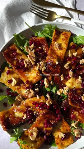 It’s called a ✨halloumi✨ salad for a reason Be for real though the halloumi is the best part and sue me if I want a lot of it. This recipe is also known as my Hot Honey Halloumi Salad and it’s bomb so let’s get to it👇🏽 Ingredients:  • 1 package of halloumi, sliced  • 2 tbsp olive oil • salt & pepper, to taste • chili flakes, to spice taste • 1-2 tbsp honey, drizzled • 2 handfuls of arugula • 2 tbsp pomegranate seeds • 2 tbsp chopped walnuts • 1/2 lemon, squeezed  How to make:  1) add olive oil to a pan on medium high heat, and then lay down the halloumi slices.  2) add salt and pepper to taste, as well as chili flakes and honey to drizzle. Allow to cook on the one side for 2-3 minutes until a brown crust has formed. 3) flip the halloumi on the other side and allow to cook for 1-2 minutes or until a crust has formed again. It happens quick!  4) on a plate, lay down a bed of arugula. Place the grilled halloumi on top, and then top with pomegranate seeds, walnuts, and lemon. Enjoy!  Who’s on team a f*ck ton of halloumi!?💁🏼‍♀️🙋🏼‍♀️ . . . #saltfatacidheat #sweetandspicy #halloumi #grilledhalloumi #sweetandsalty #halloumirecipes #healthyfood #sidedishes #halloumisalad #easyhealthyrecipes #holisticrecipes #foodcontentcreator #foodcontent #holistichomecooking 