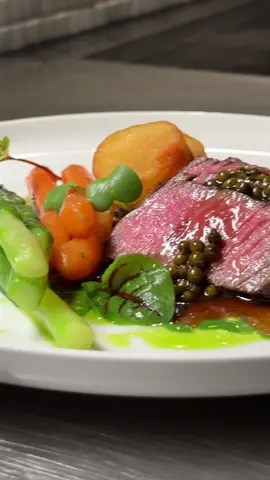 Episode 44 | The easiest two-course dinner to keep her coming back for more. #steak #dinner #food #yummy #dessert What are my options? - The first course is fillet steak served with green pepper sauce, baby carrots, asparagus, triple-cooked coin chips, spinach puree, and parsley oil. - The second course is a spring/summer tart filled with poached apricots, vanilla cream, mint gel, apricot gel, almond sponge cake, meringue and lemon ice cream.  Which should you choose? - The first course is relatively easy to make. It requires organisation in managing your hot plates and getting the correct internal temperature for the fillet. I always suggest one backup portion and trial with the fillet to see the perfect cooking time as every oven is slightly different. My oven temperature is 200°C/392°F for 3 minutes, and it comes out medium rare for 10 minutes of rest.  Difficulty = Medium - For the tart, it's more technical, but you could simplify some of the elements. For instance, you replace the ice cream with a store-bought flavour, like vanilla or sorbet. For pastry shells, you could also simplify by using moulds rather than tart rings.  Difficulty = Medium to technical Who should you serve this to?  - The fillet steak dinner, I would recommend at most four people as it becomes more difficult to manage the hot elements.  - The apricot tart could be served to several people.  What is my favourite plate? I love the apricot tart; it is so fantastic and fresh with really nice textural elements. The steak dinner is a bit more classic; nonetheless, it is still a nice dinner alongside a good wine.
