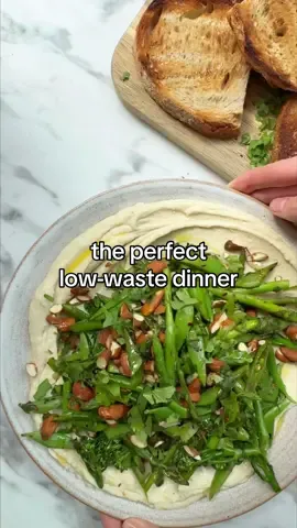 This simple recipe for super veg with lemony butter bean mash is perfect for low-waste living. The veggies are interchangeable, meaning you can make this anytime you have leftovers in the fridge to use up. Likewise, the butter beans can be swapped for any white bean - they all turn into a beautifully smooth, creamy, nutrition-filled mash in no time. INGREDIENTS - 4 tbsp olive oil - 4 cloves garlic, thinly sliced - 2 x 400 tins butter beans, drained - 1 heaped tsp ground cumin  - 1 lemon, zested & juiced - handful of coriander (about 30g), roughly chopped - 2 handfuls of almonds (about 100g), roughly chopped - pinch of dried red chilli flakes (optional)  - 400g quick-cook green vegetables (we used tenderstem broccoli, asparagus & sugar snap peas), cut into even-sized pieces - pinch of sea salt flakes & black pepper METHOD 1. Warm 2 tablespoons of olive oil in a large frying pan set over medium heat; add the garlic and cook for 3–5 minutes until golden (watch carefully that the garlic doesn’t burn else it will taste bitter). Pour both the garlic and oil into a high-speed blender.  2. Add the butter beans, cumin, the lemon juice (save the zest for later), 1 teaspoon of salt and plenty of black pepper to the blender; blitz until smooth. You may need to add more olive oil or splash of water depending on what type of blender you’re using. 3. In a small bowl, mix together the lemon zest, coriander, almonds, chilli flakes (if using) and a pinch of salt; set aside.  4. Set the frying pan back over medium–high heat — there should be enough residual oil in the pan, but you can add more as needed. Once hot, add the vegetables and a splash of water; cook for 5 minutes until just tender. Remove the pan from the heat and stir through the herby-almond mixture. 5. To serve, spoon the butter bean mash onto a large plate or serving platter and spread out using the back of the spoon. Pile on the vegetables, dress with a little more olive oil and add a pinch of sea salt flakes and black pepper. Serve immediately with fresh bread or toast. 