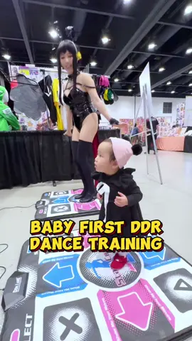 This is her first time playing DDR at @Otafest ! She looks confused at first, but eventually had fun stepping on the mat 💕  #ddr #babydance #babyfirst #otafest 