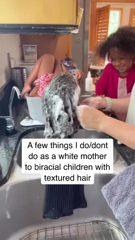 Learning to care for my children’s hair, knowing the role that it would play in their identity is one of the most important things I’ve done and I’m still learning. But it’s so much more than just knowing what products to use, even though that’s important. It’s also knowing how what we say and how we act can impact how they view their own hair, especially as a white parent to black or brown children. If I say things like “this is taking forever!” or complain when when I’m detangling they’re going to feel like their hair is a burden and while it can be time consuming it is not ever a burden.  Following accounts or other sources that my children can use to see different hairstyles and then pick which ones they like gives them power and control over their hair from a young age. Learning to do those hairstyles through YouTube, a friend or relative or even taking an online course is a great investment into their relationship with their hair.  Knowing that even on my worst day it may take 5 minutes to brush through my hair, and knowing that my kids know that…I could never feel good dismissing their discomforts and pains when it takes hours to do theirs. I don’t and never will understand what it’s like to sit patiently at 4 years old for 2 hours while I get my hair done, I never needed to do that. I tell them every hair day that they’re the toughest girls around. I remind them that their strong and amazing and capable. I would rather tell them that than tell them to suck it up.  Braids and other protective styles are just that. They are not an excuse to not learn to care for your child’s natural hair. 😉 Their hair is important. And it’s your job to not only know and understand that but to foster an environment where THEY know and understand that. 💛🫶🏼 #hairday #washday #washdayroutine #mixedkids 