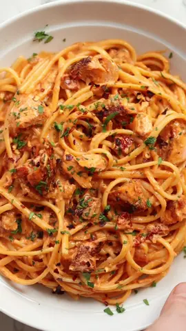 Day 22 | 30 days of 30 minute dinners 😋 This is the sister recipe to one of my all-time most popular recipes. I’m confident you’ll love this just as much (if not more 😉). Enjoy!! Chris x SPICY SALMON PASTA | Serves 2 INGREDIENTS ➡️SALMON 2x 120-150g / 4-5oz boneless skinless Salmon Fillets, brought close to room temp 1/2 tsp EACH: Smoked Paprika, Cayenne Pepper 1/4 tsp EACH: Salt, Black Pepper 2 tsp Olive Oil 1 tbsp Butter ➡️SAUCE 200g / 7oz Linguine (or other long-cut pasta) 1 small White Onion, finely diced 2 cloves of Garlic, finely diced 6 Sun-Dried Tomatoes, finely diced 1/2 tsp Chilli Flakes (see notes) 2 tbsp Tomato Puree (Tomato Paste in US) 60ml / 1/4 cup Dry White Wine (optional) 80ml / 1/3 cup Chicken Stock 160ml / 2/3 cup Double/Heavy Cream (leave at room temp) 30g / 1oz / 1/3 cup freshly grated Parmesan 1 tbsp finely diced Fresh Parsley Salt & Black Pepper, as needed METHOD 1️⃣In a small pot combine the salmon seasoning, then evenly sprinkle over both sides of the fillets. 2️⃣Heat 2 tsp oil in a large non-stick pan over medium-high heat. Add the fillets and fry for 3 minutes until lightly charred and crisp on the bottom, then flip them over and fry for another 2 minutes. Melt in the butter and baste the fillets for a further minute, or until they're just about cooked through the centre (they will continue cooking so don't worry too much). The salmon will lightly blacken from the seasoning, but you don't want it to burn, so lower the temp slightly if you need to at any time during this. Remove the fillets and place them on a plate to one side, then lower the heat to medium. 3️⃣At this point you can add the pasta to salted boiling water and cook it until it is al dente. Don't drain. 4️⃣Add the onion to the leftover fat in the pan and fry until soft and golden, then add the garlic, chilli flakes and sun-dried tomatoes and fry for a further minute. Stir in the tomato puree and fry for a minute, then pour in the wine. Cook it out for a few minutes, or until it's almost completely evaporated and the pungent smell of alcohol disappears, deglazing the pan with your wooden spoon as needed. 5️⃣Pour in the stock and cream then give everything a good stir. Bring to a gentle simmer, then turn the heat to low. Use your tongs to transfer the cooked pasta straight from the pot into the pan, then toss to coat in the sauce. Toss in the parmesan and parsley until the parmesan melts. Roughly break up the salmon, then toss that in too (alongside any resting juices). If the sauce over-thickens just toss in a splash of the pasta water. 6️⃣Check for seasoning/spice and adjust if needed then serve and enjoy!