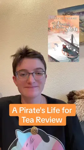 Ahhhhhh this book just makes you feel so cozy and safe even though it's also very chaotic, also the pirate, Serina is so freaking awesome! #sapphicbooks #pride2025 #cozyfantasy #queerbooktok #apirateslifefortea 