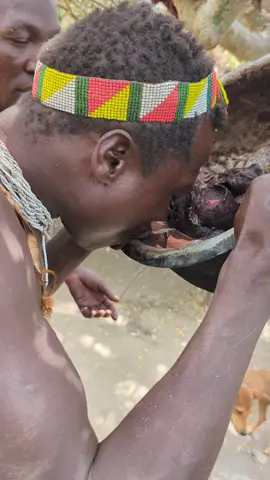 Hadzabe tribe eating breakfast soup