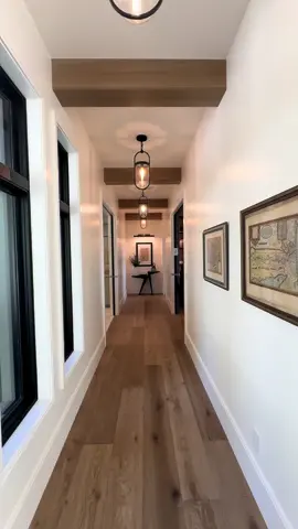 Hallway lighting is always a must!  Home #23 in UV PoH by Brinkerhoff Custom Construction  #hallway #homelighting #woodflooring #pendantlighting #moodlight #homehallway #lighting 