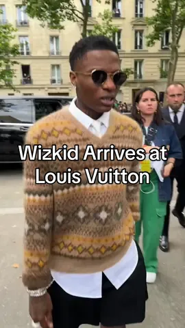 Replying to @Surozee Here’s a better angle. #Wizkid rocks a v-neck sweater and shorts to the spring 2025 #LouisVuitton show. 