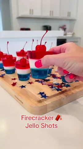 Firecracker 🧨 Jello Shots for kids ❤️ These are SO perfect for the 4th of July 🇺🇸  Ingredients: • 1 box (6 oz) Blue Berry @jello  • 1 box (6 oz) Strawberry Jello   • 1 can of sweetened condensed milk • 2 envelopes of unflavored gelatin • maraschino cherries 🍒 • boiling water  💙Bottom Layer - Blue Layer💙 Add the blue jello to 2 cups of boiling water and stir super well. Add the blue jello to the bottom of the plastic cups and put them in the refrigerator for 2 hours.  🤍Second Layer- White Layer 🤍 Boil one cup of water and then sprinkle 2 packets of unflavored gelatin on top and let sit for 3 minutes. After 3 minutes whisk it super well and then add 1 can of condensed milk to the mixture and whisk again. Pour this white layer on top of the blue layer once the  blue layer has been in the refrigerator for 1-2 hours.  🤍🚨You must make sure the white layer is at room temperature before pouring it on the blue layer. 🤍🚨 Put it in the refrigerator for 1-2 hours after you pour the white layer on the blue layer. 🤍 ❤️Last Layer- Red Jello ❤️ Add the strawberry jello to 2 cups of boiling water and stir super well. Pour the red layer on top of the white layer once the  white layer has been in the refrigerator for 1-2 hours.  ❤️🚨You must make sure the red layer is at room temperature before pouring it on the white layer. ❤️🚨 Put it in the refrigerator for 1-2 hours after you pour the red layer on the white layer. ❤️ Before serving, cut a small hole out of the center of each jello cup and pop a maraschino cherry into it.  Enjoy 🧨❤️💙🇺🇸 #4thofjuly #4thjuly #forthofjuly #july4thweekend #redwhiteandblue #kidfriendlyfood #kidfriendlyrecipes #kidfriendlyrecipes #cocktailrecipes #sprite #EasyRecipes #forthofjuly🇺🇸 #redwhiteandroyalblue #momhacks #mocktails #mocktail #cocktails #cocktail #cherries #cherry