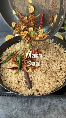 Mash ki Daal (Urad Daal)  Ingredients: - 1 & a half cup urad daal - 3 cups water - 1 cinnamon stick - 1 tsp cloves - 1 tsp black peppercorns - Salt to taste - 1 tsp chilli flakes - 1/4 cup ghee - 1 medium onion, sliced - 1 tbsp thinly sliced cloves - 1 tbsp julienne cut ginger - 1 tsp cumin seeds - 3/4 dried red chillies - Curry leaves - Green chillies - Chopped coriander for garnish Instructions: 1. Wash and soak the urad daal in water for at least an hour. 2. In a pan, add the soaked daal, 3 cups of water, cinnamon stick, cloves, black peppercorns, salt, and chilli flakes. Boil until the water dries up and the daal is cooked through. 3. In a separate pan, melt ghee and add sliced onion. Cook until the edges are slightly browned. 4. Add thinly sliced cloves and julienne cut ginger. Once browned, add cumin seeds and dried red chillies. 5. Turn off the heat and add curry leaves and green chillies. 6. Pour the tarka over the cooked daal and garnish with chopped coriander. 7. Mix well and serve hot. Enjoy your tarka mash ki daal!
