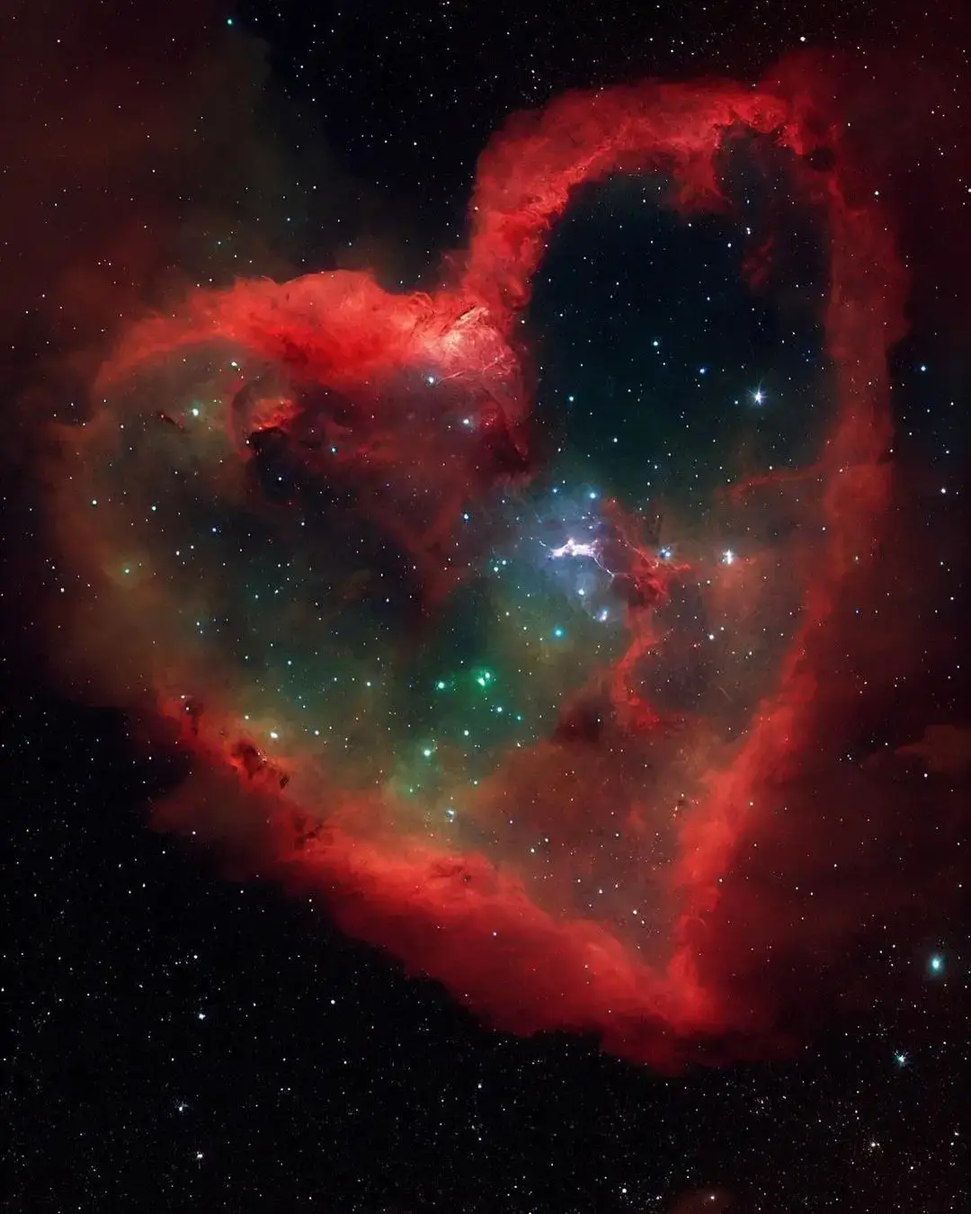 #Astronomy #nebula The Heart Nebula IC 1805 is an emission nebula located 7,500 light years from Earth. It is located in the Perseus Arm of the Milky Way Galaxy in the constellation Cassiopeia. This nebula emits glowing gas and dark lanes of dust.
