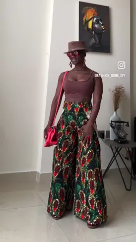 #day2  Enthralled by the striking African print wide-leg wrap pants, beautifully complemented by earthy tones and a lively pop of orange from the bag.  #Summer  #summerlook  #summervibes  #summerfits #fashion #style #sewistsofinstagram #whattowear #fashion #StreetStyle #bebold #standoutinportrait 