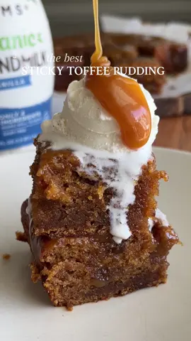 STICKY TOFFEE PUDDING  Sticky, soft, warming, and essentially like a warm little hug in every bite 🥹 Made completely vegan using @Califia Farms Organic Vanilla Almondmilk ✨ Recipe below OR go to my website through the link in my bio 🤎 #Recipe Details: Ingredients: - 1 1/3 cup pitted dates - 2/3 cup boiling water - 1 tsp vanilla extract - 3/4 cup @califiafarms Organic Vanilla Almondmilk - 1 1/2 tsp apple cider vinegar  - 2 cups + 1 tbsp all-purpose flour - 2 tsp baking powder - 1/2 tsp baking soda - 1/2 tsp salt - 1/4 cup + 3 tbsp cane sugar  - 1/4 cup + 3 tbsp dark brown sugar - 2/3 cup vegan butter, at room temp - 1/2 cup + 2 tbsp DF yogurt  - 2 tbsp molasses Toffee Sauce: - 1/2 cup + 2 tbsp light brown sugar - 1/4 cup vegan butter - 1 tbsp molasses - 3/4 cup coconut cream - 1 tsp salt Instructions: Start by preparing the date paste. Chop the pitted dates and add them to a medium bowl with the boiling water. Soak for 20-30 minutes. Set aside. In a small bowl, whisk together the vanilla almondmilk and apple cider vinegar. Allow to sit for 5 minutes (this will act as buttermilk). Preheat the oven to 320F. Grease and line an 8x8” baking pan with parchment paper. Make the batter. In a medium bowl, whisk together the dry ingredients. Set aside. Once the dates have softened, add the mixture (with the water) to a blender. Blend until mostly smooth, and then stir in the vanilla. Set aside. In a large bowl, cream together the butter and sugars until light and fluffy.  Add in the yogurt, and whisk.  Alternate between adding the buttermilk and dry ingredients, whisking in between each. Use a spatula to fold in the date paste. Transfer the batter to the baking pan. Bake at 320F for 40-45 mins, until a toothpick inserted into the middle comes out with moist crumbs. Make the toffee sauce. Add all of the ingredients to a saucepan and bring to a simmer. Turn the temperature down and continue to simmer until thickened (~2-3 mins). Use a fork to poke holes all over the surface of the pudding. Pour half of the toffee sauce on top, and then allow to cool for 30 minutes. Slice and serve the pudding warm and a scoop of DR vanilla ice cream and toffee sauce. Enjoy! #stickytoffeepudding #cake #stickytoffeepuddingrecipe #puddingcake #cakerecipe #vegan #dairyfree #veganrecipe #dairyfreerecipe #dessert #vegandessert #dairyfreedessert #veganbaking #baking #icecream #vanillaicecream 