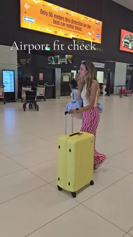 Airport outfit on point. Colourful and comfy. Bonus points for a colourful suitcase #OOTD #traveloutfit #dopaminedressing #summerfits 