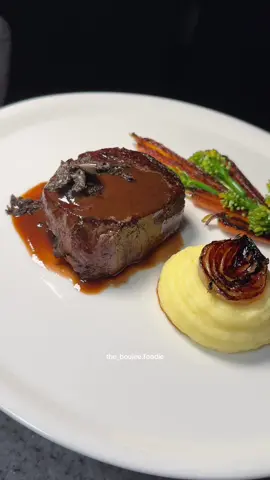 Filet Mignon, roasted veggies of baby carrot and broccolini florets and black truffle freshly shaved. A silky potato, cipollini caramelized onion, and a demiglace from my beef braise.  @weirsbutchers got the best steaks 🥩 ♥️ Plating this up after cooking the steak perfectly 240g in weight but thickness matters for cooking this was 2 inches (5cm). I know it’s conventional to use meat thermometers but I don’t like holes in my filet. Luckily, the hot caster iron sear does the trick, oven cooked for another 4 minutes 180°C then return to the fire for butter basting. Turn off the heat, a cast iron pan stays very hot so you’ll need to rest your filet on a mise so that the juices redistribute and it’s perfectly rested without overcooking. ♥️ #steak #beef #wagyu #plating #theartofplating #truffle #blacktruffle #dinnerplate #sauce #steakdinner 
