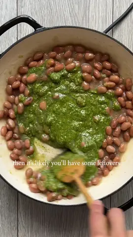 We had rocket pesto pasta and now we’re having rocket pesto beans, obviously. This pesto really is it, soo punchy and refreshing! Unfortunately when heated it loses its vibrant green colour but it definitely doesn’t lose its flavour!  Ingredients: 1 jar borlotti beans (or any beans) 1 shallot 4 cloves of garlic  3-4 tbsp rocket walnut pesto (2 posts back!)  124ml dry white wine Burrata and lemon  Method: Fry the diced shallot in olive oil for a couple minutes and then add the minced garlic and fry for another minute or so, seasoning as you go. Pour the wine, let it bubble for a moment and then add in the beans and their juices and then stir through the pesto. Bring it to a quick simmer and then remove from the heat (or simmer for longer if you want it thicker). Top with burrata, olive oil, lemon juice and zest and dive in #beans #rocketwalnutpesto #FoodTok 