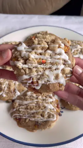Peach crumble cookies🍪🍑 Ingredients Cookies - 1/2 cup butter, softened - 1 cup granulated sugar - 1 large egg, room temp - 2 cups all purpose flour - 1/2 tbsp cinnamon - 1/4 tsp salt - 1/4 tsp baking powder - 1/4 tsp baking soda - 3/4 cup peaches, diced (optional: you can toss these in melted butter and cinnamon) Crumble - 5 tbsps unsalted butter - 1 cup all purpose flour - 1/4 cup sugar - 1/2 tsp cinnamon Peach mixture: - 1 peach, diced - 3 tbsp unsalted butter, melted - 1/2 tbsp cinnamon Icing: - 1 cup powdered sugar - 2 tbsps milk Directions: - Preheat your oven to 350 degrees F. Line a baking sheet with parchment paper and set aside.  - In a bowl, combine the crumble topping ingredients with your hands until it’s crumbly. Don’t overmix. Set in the fridge while you prepare the batter. - For the peach mixture, toss the diced peaches in melted butter and cinnamon. Set aside. Optional: you can do the same for the peaches for the cookie dough. - In a bowl, combine the flour, cinnamon, baking powder, baking soda, and salt. Set aside. - In a large bowl, beat together the butter and granulated sugar for 3-5 minutes, until light and fluffy.  - Add the egg. Beat well. - Fold in the dry mixture until almost combined. - Fold in the peaches with a spatula. Don’t over mix. - Using a cookie scoop, roll dough into a ball and place on the prepared pan, at least 3 inches apart. Make a well in the middle of the dough ball so there’s an indent. - Place a dollop of the peaches from the peach mixture in the middle. Spoon the crumble on top. - Bake at 350 for 16-18 minutes. When there’s 5 minutes left on the oven timer, take the cookies out and place another layer of crumble on top then finish baking them until the middle has set. - Let baked cookies set on the pan for 10 minutes, then transfer to a cooling rack. Let cool completely before adding the icing. - For the icing, combine the powdered sugar and milk. If it’s too runny, add a little more sugar, and vice versa.