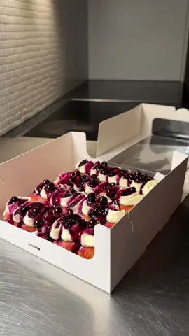 Do you take delivery? I serve a mouthful. #doughnut #papanasi #vanillacream I present you with a beautiful Romanian dish called papanasi, cheese doughnuts served with blueberry jam, sour cream, and other variations. My take here is a spin-off with the same elements, including a yeast cottage cheese doughnut served with vanilla lemon cream, sour cream, white chocolate whipped cream, and vanilla blueberry sauce. One word: divine.