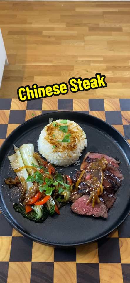 Taking a traditional steak and giving it a delicious Chinese twist! This 300g rump steak marinated with MSG, oyster sauce, mushroom soy, and five spice, then oven-roasted to perfection. Paired with stir-fried veggies and served with fluffy white rice, it’s a fusion feast that’s perfect for dinner. Check out the full recipe below and enjoy! 🍲🥢 Ingredients 	•	For the Steak: 	•	300g rump steak 	•	1 tsp MSG 	•	1 tbsp oyster sauce 	•	1 tbsp mushroom soy sauce 	•	1 tsp five spice powder 	•	For the Stir-Fry: 	•	1/2 onion, thinly sliced 	•	1 garlic clove, minced 	•	1/2 red capsicum, thinly sliced 	•	1 whole bok choy, cleaned and chopped 	•	1/4 cup neutral oil 	•	For the Sauce: 	•	1/4 cup oyster sauce 	•	2 tbsp water 	•	Dash of fish sauce 	•	1 tbsp rice wine vinegar 	•	For Serving: 	•	White rice 	•	Sesame seeds 	•	Spring onions (optional) Recipe 	1.	Marinate the Steak: 	•	Season the rump steak with MSG. 	•	Brush with oyster sauce and mushroom soy sauce. 	•	Sprinkle with five spice powder. 	•	Marinate for 30 minutes. 	2.	Cook the Steak: 	•	Preheat the oven to 135°C (275°F). 	•	Roast the steak for 30 minutes or until it reaches an internal temperature of 49°C (120°F). 	3.	Prepare the Stir-Fry: 	•	While the steak is in the oven, thinly slice the onion, garlic, and red capsicum. 	•	Clean and chop the bok choy. 	•	Heat neutral oil in a wok. 	4.	Finish the Steak: 	•	Remove the steak from the oven and reverse sear it in the hot oil in the wok. 	•	Cook for about 2.5 minutes, turning regularly. 	•	Set aside to rest for 10 minutes. 	5.	Stir-Fry the Vegetables: 	•	Strain the oil from the wok and return it to the heat. 	•	Add the onion, garlic, red capsicum, and bok choy to the wok. 	•	Stir-fry until tender. 	6.	Make the Sauce: 	•	Mix together the oyster sauce, water, fish sauce, and rice wine vinegar. 	•	Add the sauce to the stir-fried vegetables and toss to coat. 	7.	Serve: 	•	On a large plate, arrange the vegetables on one side and the sliced steak on the other. 	•	Place a serving of white rice in the middle. 	•	Sprinkle with sesame seeds and garnish with spring onions if available. #ChineseFusion #BeefSteak #StirFry #AsianCuisine #FusionFood #DinnerIdeas #HomeCooking #RecipeOfTheDay #FoodLovers #Gourmet #Foodstagram #InstaFood #Yummy #FoodPorn #Foodie #Delicious #CookAtHome #DinnerTime #HealthyEating #FoodPics #ComfortFood #AsianFlavors #EasyRecipe #SteakLovers #WokCooking