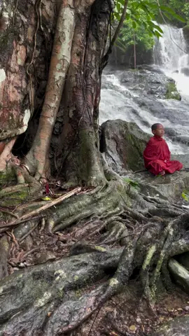 Amazing Buddhist Novice Meditating near waterfall in myanmar