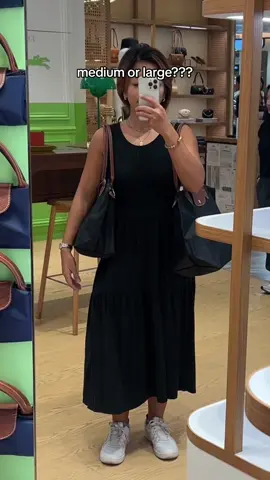 Tell me I’m not the only one torn between the M and L Longchamp Le Pliage 😅  Here’s a little size comparison when worn. I’m 5’2 BTW. Hope that helps!!  What size do you think I got?? #longchamplepliage #longchamp #longchampgirls #totebagaesthetic #totebag #lepliage 