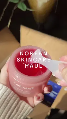 Legit gasped when I opened this box! 😫 Find all the viral k-beauty above!👆 #koreanskincare #haultok #skincarehaul #RushReady #ShopIcons #aestheticunboxing #prhaul #prunboxing #kbeauty    First thoughts— Everything smells very clean and light! Nothing has an overpowering scent, which is really nice. I’m just super excited and grateful to start my Korean skincare journey! Viral products are typically viral for a reason, so please stay tuned to see more! 🤍   1. Jelly Brush— Applicator for the jelly cream and masks.  2. Night Mask— Pink squeeze bottle with flip cap.  3. Jelly Cream— Pink jar with rose gold cap and applicator.  4. Pore Pads— Frost white color jar of 70 pads with blue cap and comes with something to easily pick up the pads. One side of the pads is embossed with texture and one side is smooth. 5. Capsule Cream— Brown jar with gold cap and small scooper. The texture is dual, there’s round yellow capsules in a clear gel. These can be mixed to a customized cream.  6. Exosome— Blue bottle with cap and pump. It comes in both 2000 and 7500. I’m going to start with the 2000.  7. R Booster Pro— 6 different setting modes. Sleek black design with silver top. 