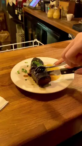 Have you ever tried Boudin Noir? A classic French delicacy from the south of France. This rich, pudding-like sausage, made from pork blood, pork snouts and a blend of spices. For where to try Boudin Noir in Paris – unlock our Paris guide on Mamakoo.com or download the Mamakoo app for free. #FrenchCuisine #BoudinNoir #ParisFood #FoodTravel #FoodGuide #TravelGuide #FrenchFood #MustTryFood