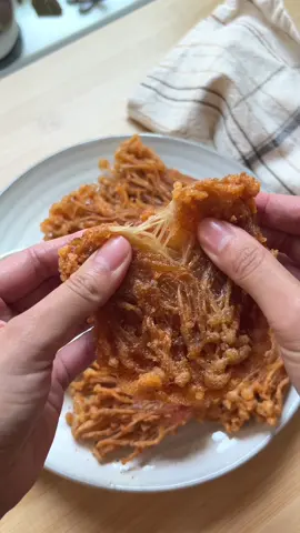 Crispy Fried Enoki Mushroom 🍄‍🟫 Calling all mushroom lovers! These fried enoki mushrooms are golden, crunchy, and packed with flavor! Each bite is absolutely addictive. It’s the perfect snack for when you want something a little different or a fun twist on your favorite crispy treat. 😋 INGREDIENTS: 2 packs Enoki mushrooms 1/2 cup potato starch 1/2 cup cornstarch 1 tsp garlic powder 1 tsp paprika 1 tsp cayenne pepper 1/4 tsp white pepper 1/2 tsp salt 1/2 cup cold water DIRECTIONS: - Start by cutting off the ends of the enoki mushrooms, then cut into 3 equal sections. - In a large bowl, combine the potato starch, cornstarch, garlic powder, paprika, cayenne pepper, white pepper, and salt. Mix well to evenly distribute the spices. - Gradually add the cold water to the dry mixture, stirring until it forms a smooth, thick batter. - Heat enough oil in a pot to around 350°F. - Dip each enoki mushroom cluster into the batter, making sure they are fully coated. - Carefully place the coated mushrooms into the hot oil, frying in batches to avoid overcrowding. Fry until they are golden brown and crispy, about 2-3 minutes per batch. - Remove the fried mushrooms with a slotted spoon and drain them on a paper towel-lined plate to remove excess oil. - Serve them hot with your choice of dipping sauce. Enjoy! #friedenokimushroom #enokimushroom #EasyRecipe 