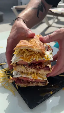 Holiday breakfast sambo 🫡 Started with a base of a generic “sandwich cheese” roll then added : • Garlic aioli • Crispy bacon • Beef tomato  • Fried eggs • Crisps • More aioli #fyp #food #foodporn #foodtiktok #Foodie #breakfast #sandwich #bacon #eggs #cheese #chef