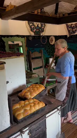 Ever find yourself craving something more than just food—maybe a taste of a place, a slice of life itself? Deep in the villages of Bucovina, there’s a woman, strong and seasoned by the land, baking paine la tava (tray bread) in a wood-fired soba. This isn’t just bread; it’s an edible time capsule. Watching her expertly shape three giant loaves, each as big as the tray itself, you can sense the pride and precision that goes into every step. It’s the kind of experience you’d only discover if you’re willing to venture off the beaten path, into the heart of a place where tradition still reigns. In Bucovina, bread isn’t just sustenance; it’s a ritual, a connection to the land and the past. The bread, with its thick, charred crust and pillowy interior, is baked directly on the hot stones of the soba, infusing it with a smoky essence that’s the very soul of the region. Each loaf is enormous, a labor of love that takes hours to perfect. This bread doesn’t just feed the body—it feeds the spirit. You won’t find it in any city bakery, only here, in these remote villages where time has its own pace, and life is savored slowly. So, you have to ask yourself, in a world obsessed with speed and convenience, how far would you go for a taste of something real, something that carries the soul of a place in every bite? Would you travel to the ends of Romania, to a tiny village where bread is still made the way it was centuries ago? Video by @cirstean.iosif  [ Bucovina Village, Traditional Bread, Wood-Fired Oven, Soba Baking, Rural Life, Romanian Cuisine, Cultural Heritage, Handcrafted Food, Bucovina Traditions, Artisanal Bread, Romanian Rural Culture, Slow Food Movement, Culinary Heritage, Bucovina Soba, Authentic Romania, Local Gastronomy, Heritage Baking, Romanian Villages, Bucovina Bread, Bucovina Craftsmanship] #romania #bucovina #traditionalfood #breadmaking #culinaryheritage #Foodie #romaniaexplorer #travel