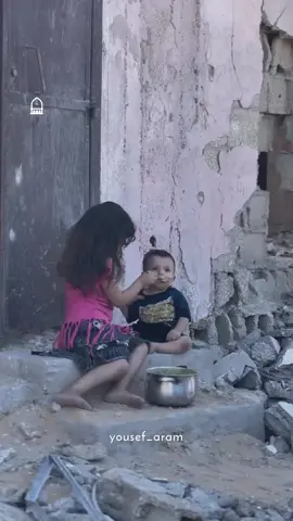 A young girl feeds her baby brother as famine spreads across Gaza #sad #palestine #gaza #freepalestine 