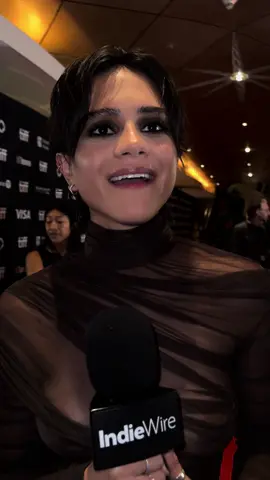 Sasha Calle gives advice to Milly Alcock, who’s taking over the role of DC’s “Supergirl.” Read our full #TIFF24 interviews from the #OnSwiftHorses premiere at the link in our bio. #indiewire #sashacalle 