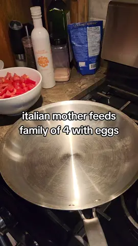 italian mother feeds family of 4 with eggs in a steel pan