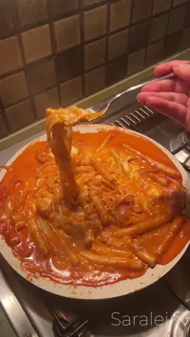 Have you heard of noodle tteokbokki? It’s the same as regular rice cakes, but in noodle form! You can make it with either bread flour or the traditional way using rice flour, potato starch, and sweet rice flour! Ingredients: 1 cup tteokbokki noodles (homemade or premade) ½ cup rice or glass noodles (cooked per packet) 2 tbsp oil 4 cloves garlic, sliced 1 medium onion, diced 1 tbsp tomato paste 1 tbsp Buldak sauce 1 tsp gochujang 1 cup cream 1 tsp soy sauce 1 tsp rice syrup Mozzarella cheese (optional) Salt to taste Homemade Tteokbokki recipe:  ½ cup white or brown rice flour ½ cup sweet rice flour ¼ cup potato starch  ½ teaspoon  salt  ¾ cup hot water  In a bowl, combine rice flour, potato starch, and sea salt. Gradually add hot water, stirring continuously to form a dough. Knead the dough until smooth. Shape the dough into long noodles or tteokbokki shapes. Boil the noodles in water for 3-5 minutes, then transfer to cold water.  (Tip: The key is to add hot water to the dough and knead it until smooth. Then, shape the dough and make sure to boil the tteokbokki pieces for 3-5 minutes, or until they float. Once boiled, transfer them to cold water to stop the cooking process. This helps them cook through evenly without staying raw in the middle. I hope this helps!) Cook rice/glass noodles per instructions and rinse with cold water. Make the Sauce: Heat oil in a pan, sauté garlic and onions. Add tomato paste, Buldak sauce, gochujang, soy sauce, and rice syrup. Cook for 2 minutes. Stir in cream and simmer until thickened. Add noodles to the sauce, mix well. Optional: Top with mozzarella, melt, and serve hot! ♥️ . . . . . . . . . . . . . . . #ramen #instantramen #ramenpink #pinkramen #buldak #buldakramen #tteokbokki #rabbokicooking #latenightramen #latenightcravings #samyangramen #asmrfood #koreanricecakes #ricecakesfromscratch #scratch 